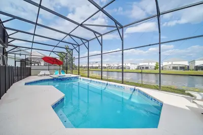 a large swimming pool with a large glass building at The Bling Estate in Kissimmee