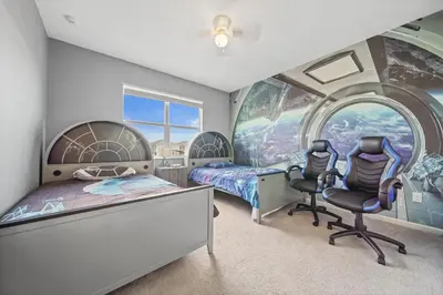 a bedroom with a star wars mural and two chairs at The Bling Estate in Kissimmee