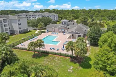 an aerial view of an apartment complex with a swimming pool at 2 Bedrooms 2 Bathrooms Secret Lake 3176-204 in Kissimmee