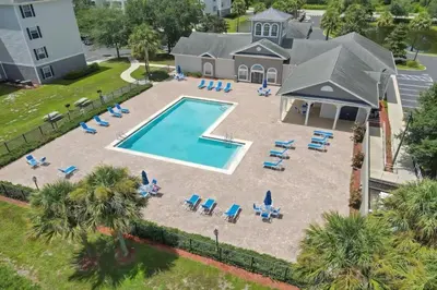 an aerial view of a swimming pool with lounge chairs and a pool at 2 Bedrooms 2 Bathrooms Secret Lake 3176-204 in Kissimmee