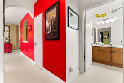 a red door in a hallway with a bathroom at Windsor Palms Mickey Themed Condo, Pool, By Disney in Kissimmee