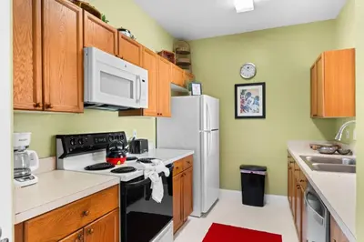 a kitchen with a stove and a white refrigerator at Windsor Palms Mickey Themed Condo, Pool, By Disney in Kissimmee
