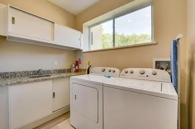 a kitchen with a washing machine and a window at Less Than 2 Mi to WDW Attractions Luxe Family Getaway! in Orlando