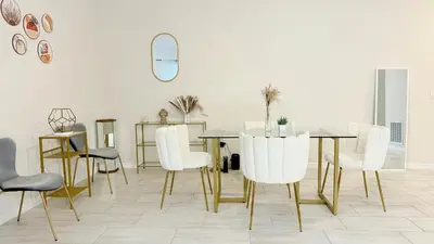 a dining room with a table and white chairs at Entire House in Orlando close to All Parks in Orlando