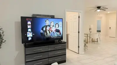 a flat screen tv sitting on top of a dresser at Entire House in Orlando close to All Parks in Orlando
