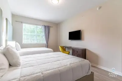 a bedroom with a bed and a desk and a television at Vista Cay Resort in Orlando