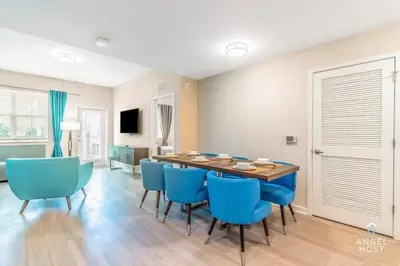 a dining room with a table and blue chairs at Vista Cay Resort in Orlando