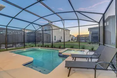 a swimming pool with a glass roof on a house at Disney Nearby! Private Pool, Movie Theater & Themed Rooms – Storey Lake Resort! in Kissimmee