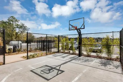 a basketball hoop on a fence on a basketball court at Dream Vacation Home – Private Pool, Themed Rooms & Resort Access – ChampionsGate! in Kissimmee