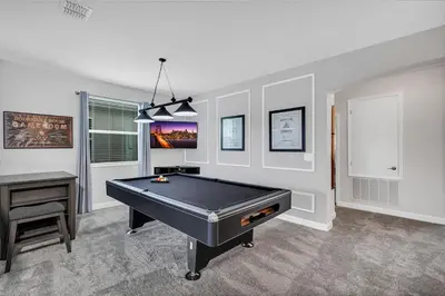 a room with a pool table and a desk at Dream Vacation Home – Private Pool, Themed Rooms & Resort Access – ChampionsGate! in Kissimmee