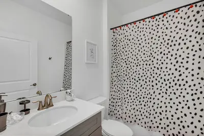 a bathroom with a sink and a toilet and a shower at Dream Vacation Home – Private Pool, Themed Rooms & Resort Access – ChampionsGate! in Kissimmee