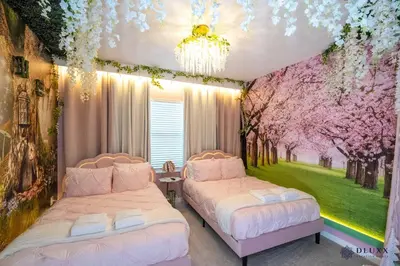 two beds in a room with flowering trees at Brand New DLuxx Top Elegance Vacation Home 1018 in Orlando