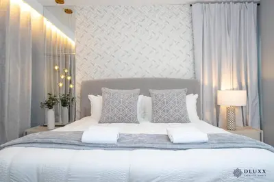 a bedroom with a large white bed with two pillows at Brand New DLuxx Top Elegance Vacation Home 1018 in Orlando