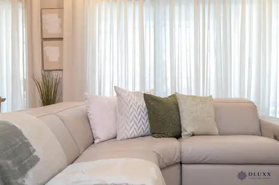 a living room with a white couch with pillows at Brand New DLuxx Top Elegance Vacation Home 1018 in Orlando