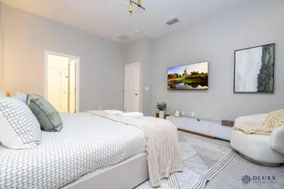 a white bedroom with a bed and a couch at Brand New DLuxx Top Elegance Vacation Home 1018 in Orlando
