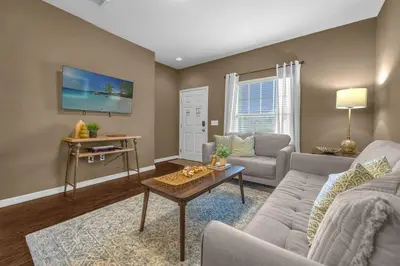 a living room with a couch and a table at Dluxx Perfect Townhouse next to Disney Parks 3204 in Kissimmee