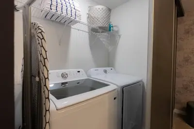 a small kitchen with a sink and a refrigerator at Amazing 03 Bedrooms 03 Baths Sleeps 08 in Kissimmee