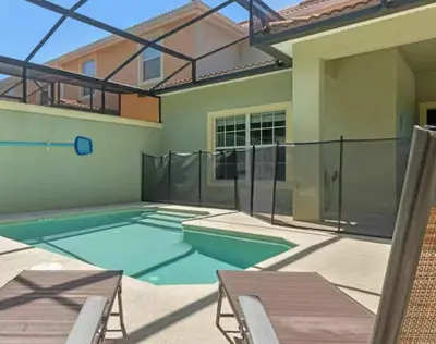 a swimming pool in the backyard of a house at Amazing 05 Bedrooms 4 Bathrooms Sleeps 14 in Kissimmee