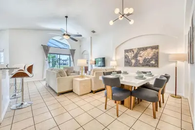 a living room with a table and chairs at Private Pool Getaway Near Theme Parks in Kissimmee