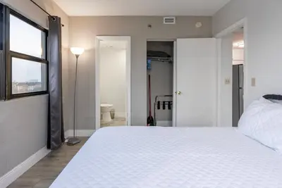 a bedroom with a large white bed and a window at Amazing 2 Bedrooms Nex to Universal in Orlando