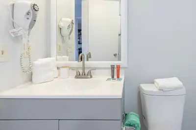 a bathroom with a sink and a mirror and a toilet at Amazing 2 Bedrooms Nex to Universal in Orlando