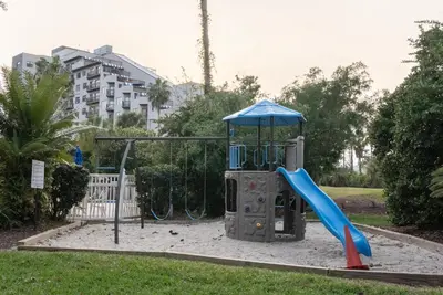 a playground with a slide in a park at Amazing 2 Bedrooms Nex to Universal in Orlando