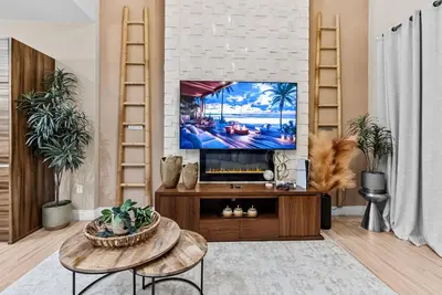 a living room with a flat screen tv at Home Luxury 4 BedsPrivate Hot Tub Close Disney in Orlando