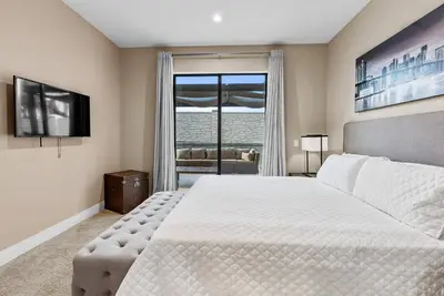 a bedroom with a large white bed and a window at Home Luxury 4 BedsPrivate Hot Tub Close Disney in Orlando