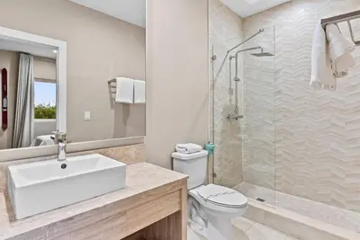 a bathroom with a toilet and a sink and a shower at Home Luxury 4 BedsPrivate Hot Tub Close Disney in Orlando