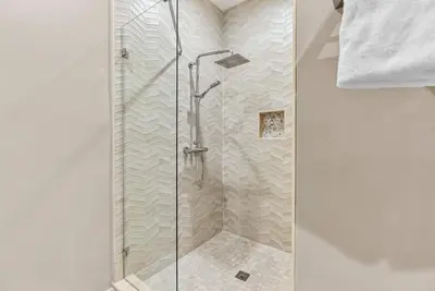 a shower with a glass door in a bathroom at Home Luxury 4 BedsPrivate Hot Tub Close Disney in Orlando