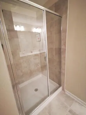 a shower with a glass door in a bathroom at Aqua Vista Storey Lake in Kissimmee