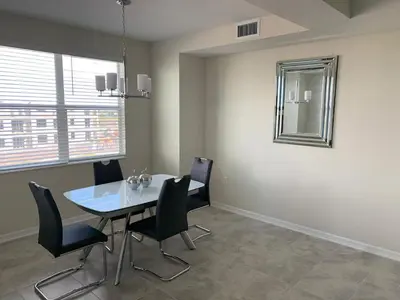 a dining room with a table and black chairs at Aqua Vista Storey Lake in Kissimmee