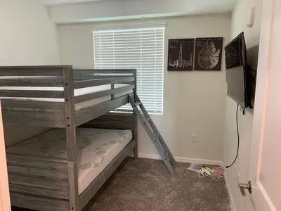 a bunk bed in a room with a tv and a bunk bed gmaxwell gmaxwell gmaxwell at Aqua Vista Storey Lake in Kissimmee
