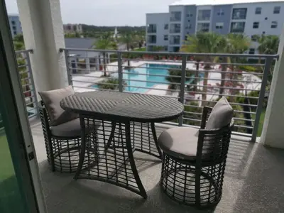 a table and two chairs and a table on a balcony at Aqua Vista Storey Lake in Kissimmee
