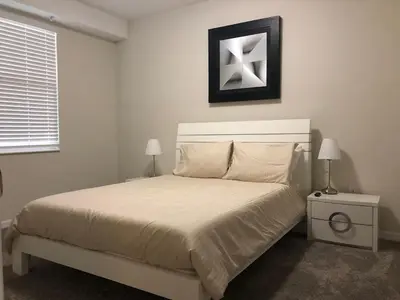 a bedroom with a white bed with a white headboard at Aqua Vista Gated Resort Style Community in Kissimmee