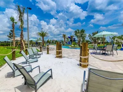 a resort with a playground with chairs and a slide at Aqua Vista Gated Resort Style Community in Kissimmee