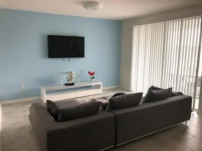 a living room with a couch and a flat screen tv at Aqua Vista Gated Resort Style Community in Kissimmee