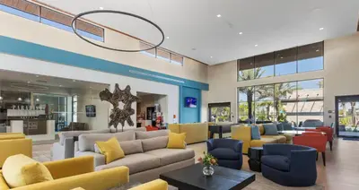 a lobby with couches and chairs in a building at Brand NEW 12Bedrooms12Bathroom At Paradiso Grande in Orlando