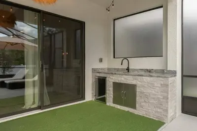 a living room with a television and green carpet at Brand NEW 12Bedrooms12Bathroom At Paradiso Grande in Orlando