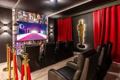 a movie room with a statue and red curtains at Brand NEW 12Bedrooms12Bathroom At Paradiso Grande in Orlando