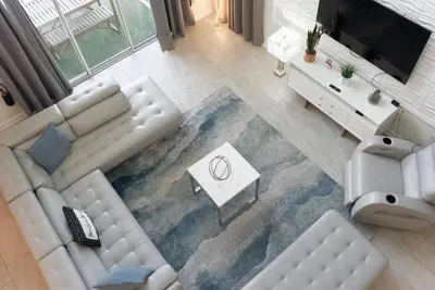 an aerial view of a living room with a white couch at Brand New 5 Bedrooms5Baths At Storey Lake in Kissimmee