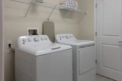 a laundry room with two washes and a sink at Brand New 5 Bedrooms5Baths At Storey Lake in Kissimmee