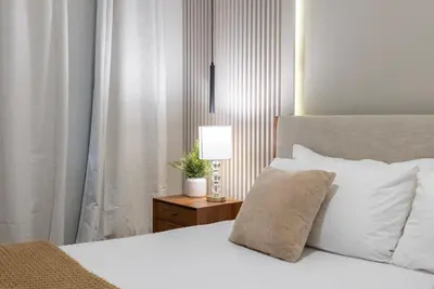 a bedroom with a bed and a lamp on a night stand at NEW Cozy 2 Bedrooms2Baths At Storey Lake in Kissimmee