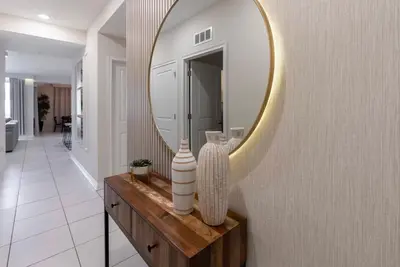 a bathroom with a large mirror on a wall at NEW Cozy 2 Bedrooms2Baths At Storey Lake in Kissimmee