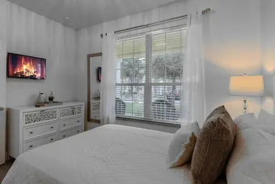 a white bedroom with a bed and a window at Amazing 3 Bedrooms with Private Pool- Close to Disney in Orlando