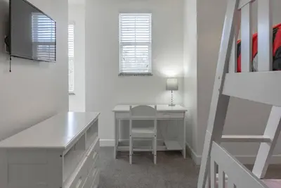 a white room with a desk and a chair at Amazing 3 Bedrooms with Private Pool- Close to Disney in Orlando