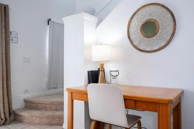 a desk with a chair and a mirror on the wall at Charming Vacation Home 9 miles From Disney 1065 in Kissimmee