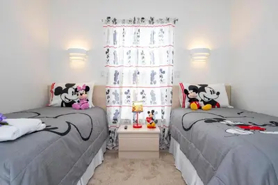 a bedroom with two beds and a window at Charming Vacation Home 9 miles From Disney 1065 in Kissimmee