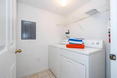 a laundry room with a washer and dryer at Charming Vacation Home 9 miles From Disney 1065 in Kissimmee