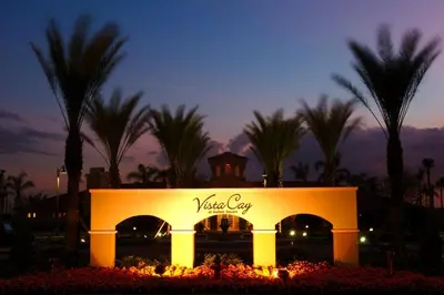 a sign for a hotel with palm trees in the background at Epic Universe Vista Cay Deluxe Condo, Near the Parks! - 3006 in Orlando